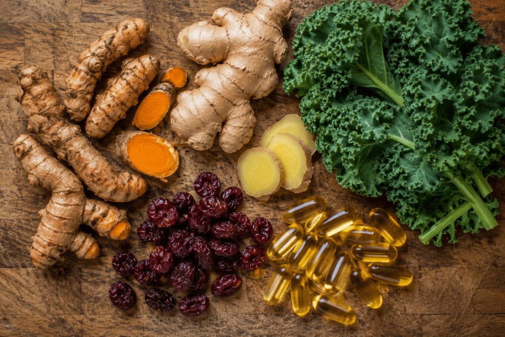  lay of turmeric root, ginger, tart cherries, and omega-3 capsules on kitchen counter