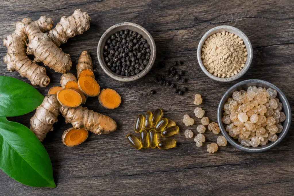 Flat-lay of turmeric root fish oil capsules and anti-inflammatory supplement ingredients